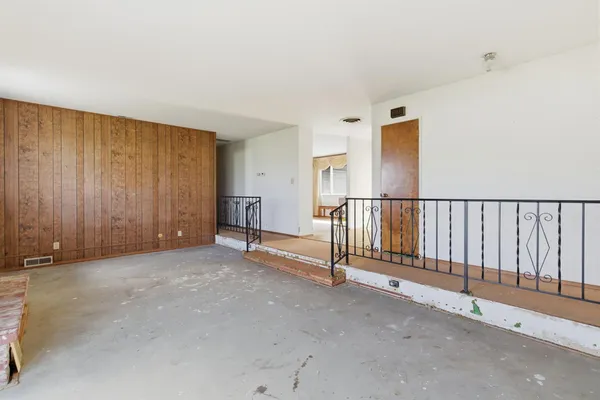 a kitchen with a refrigerator and more cabinets