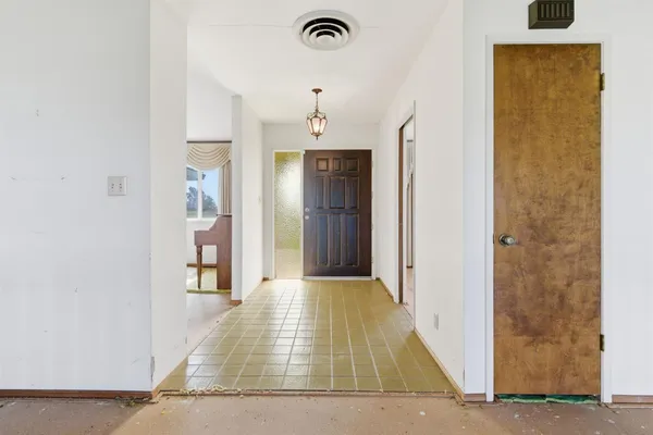 a view of a hallway with wooden floor and cabinet