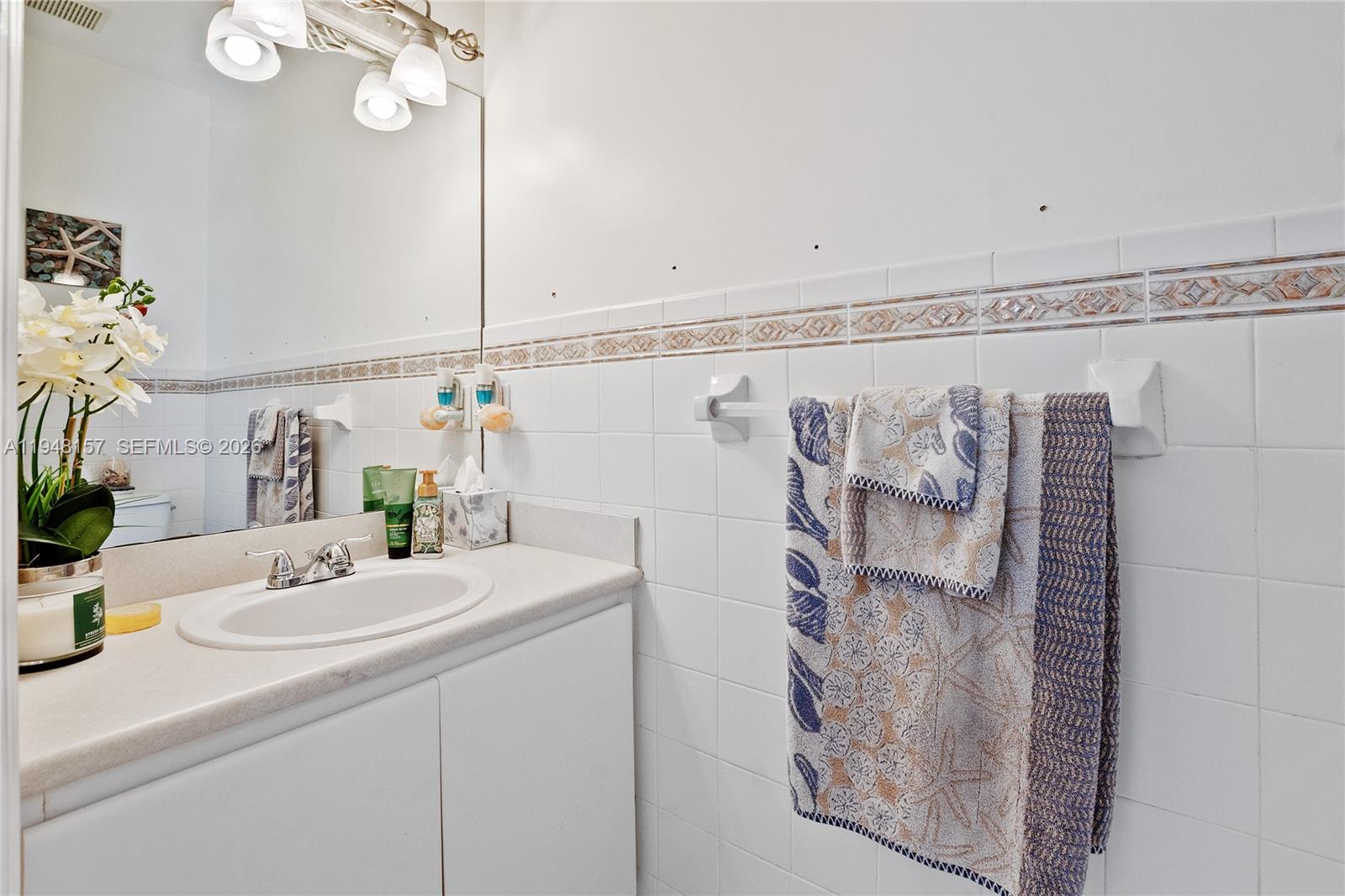 3363 Southwest 169th Terrace Miramar, FL 33027 - Photo 4 of 21 a bathroom with a sink and a mirror