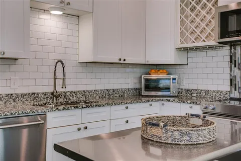 a kitchen with stainless steel appliances granite countertop a sink stove and cabinets