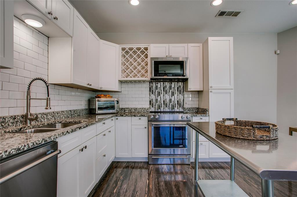 834 South Polk Street Dallas, TX 75208 - Photo 16 of 38 a kitchen with stainless steel appliances granite countertop a stove and a sink