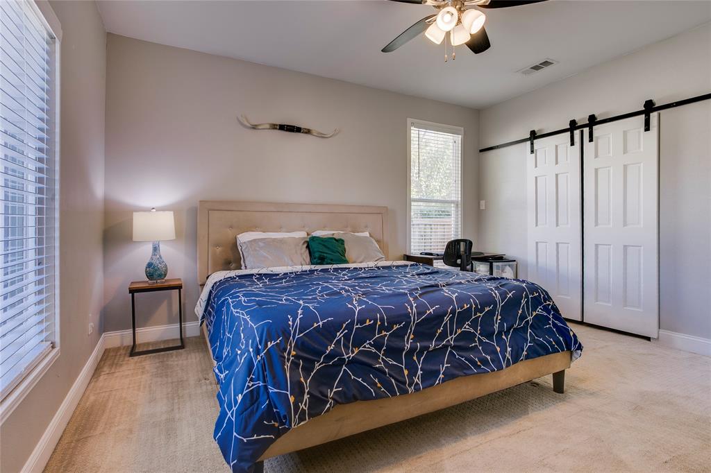 834 South Polk Street Dallas, TX 75208 - Photo 18 of 38 a bedroom with a bed chandelier and a window