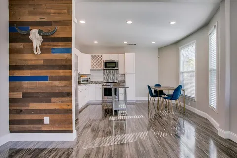 a view of kitchen with kitchen island dining table and chairs