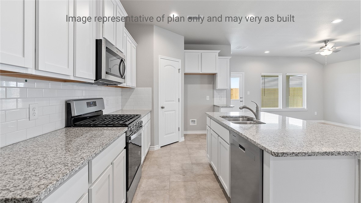 1411 Choctaw Road Sinton, TX 78387 - Photo 7 of 28 a kitchen with stainless steel appliances granite countertop a sink stove and refrigerator