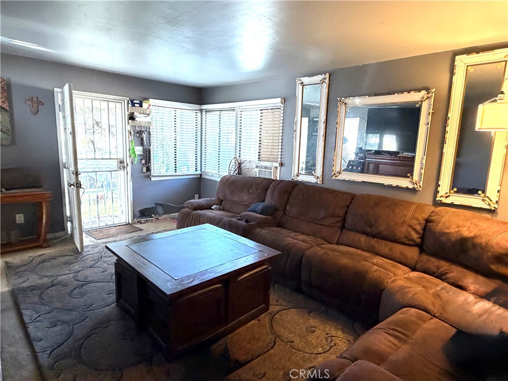 5846 Gardenia Avenue Long Beach, CA 90805 - Photo 21 of 26 a living room with furniture and a flat screen tv