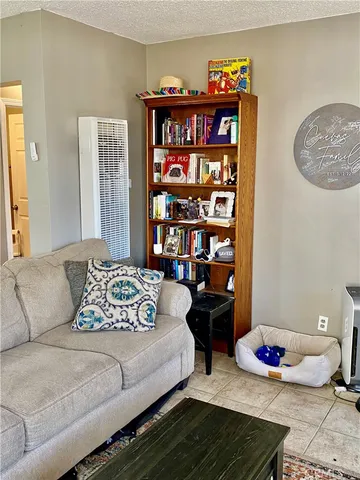 a bedroom with furniture and a book shelf