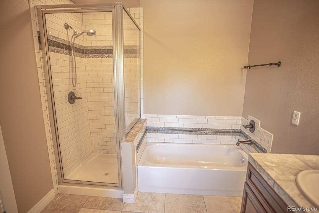 710 East Baseline Road Lafayette, CO 80026 - Photo 15 of 33 a bathroom with a tub and shower