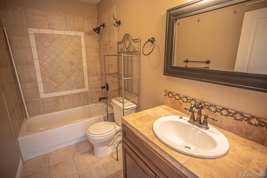 710 East Baseline Road Lafayette, CO 80026 - Photo 20 of 33 a bathroom with a sink a toilet and a mirror