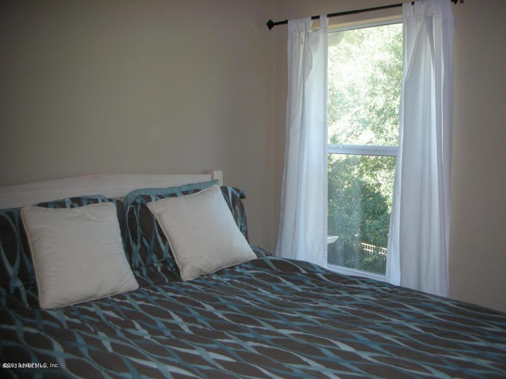 3409 South Saxxon Road St. Augustine, FL 32092 - Photo 11 of 15 a bedroom with a bed and wooden floor