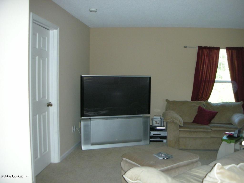 3409 South Saxxon Road St. Augustine, FL 32092 - Photo 14 of 15 a living room with furniture and a flat screen tv