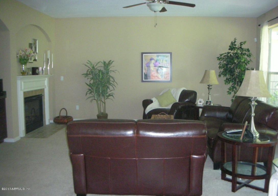 3409 South Saxxon Road St. Augustine, FL 32092 - Photo 3 of 15 a room with a table chairs and potted plant