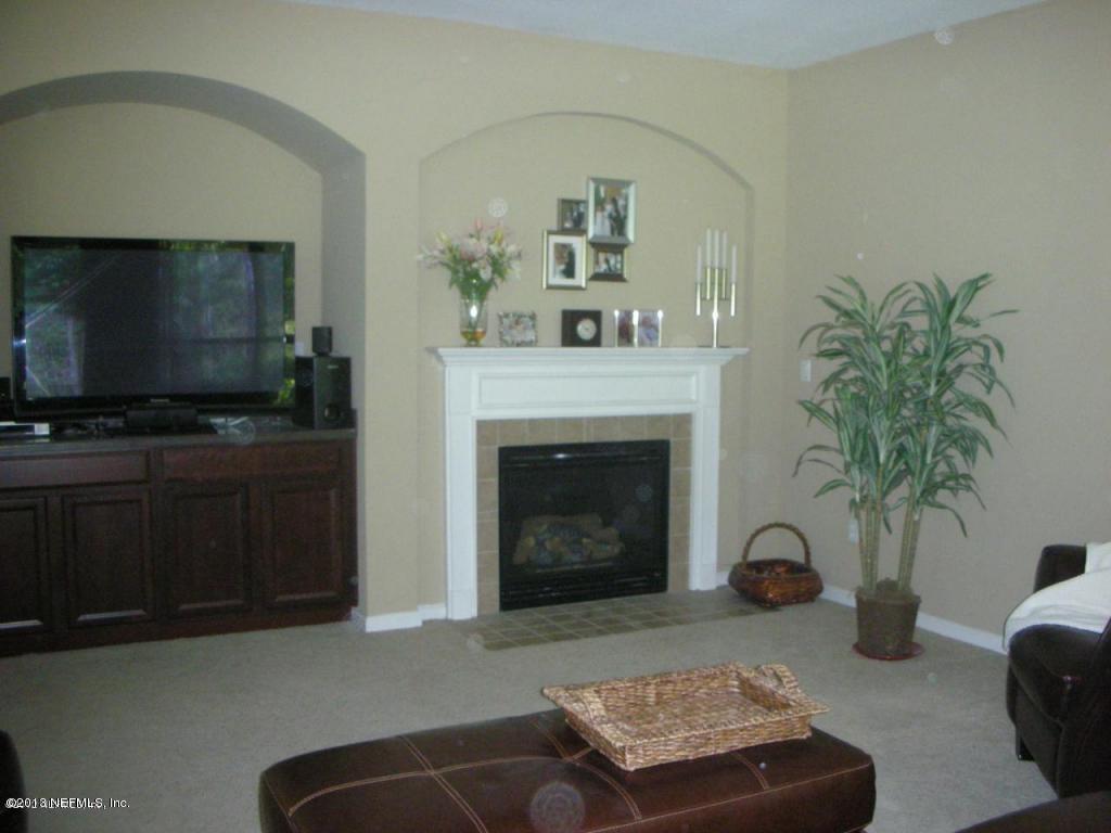 3409 South Saxxon Road St. Augustine, FL 32092 - Photo 4 of 15 a living room with furniture and a fireplace