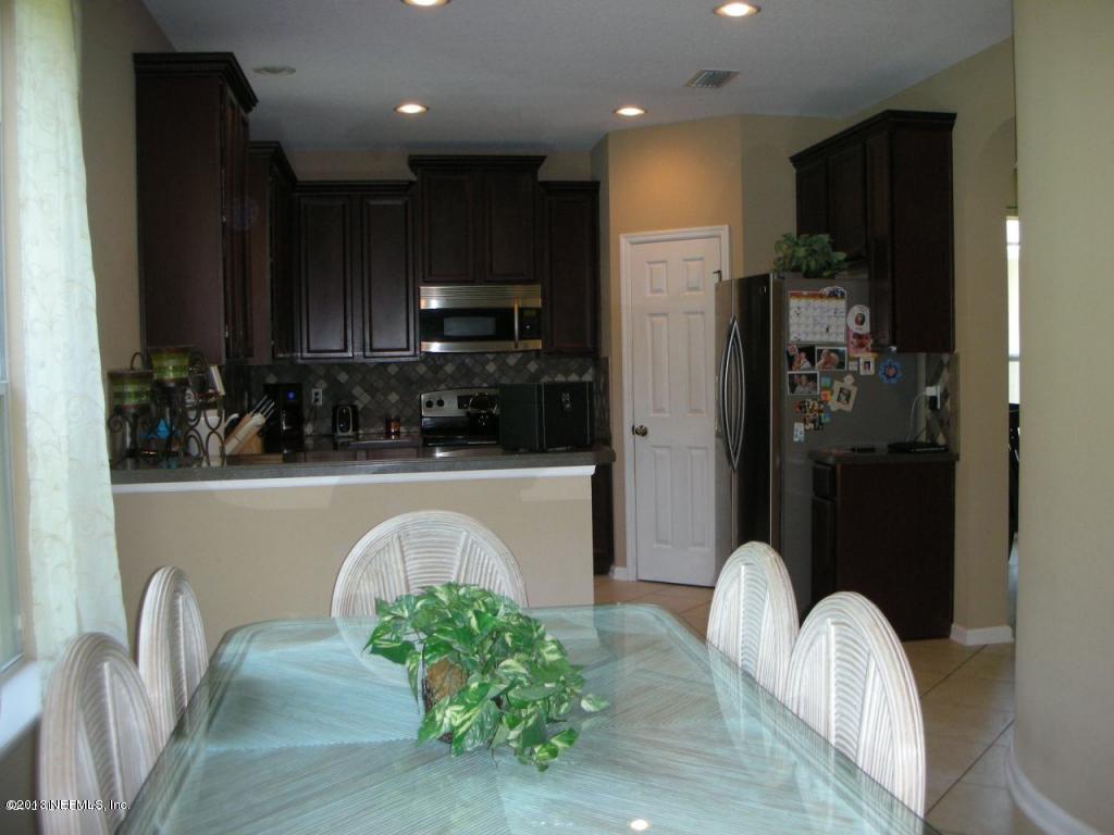 3409 South Saxxon Road St. Augustine, FL 32092 - Photo 6 of 15 a view of kitchen with stainless steel appliances granite countertop a refrigerator and a sink