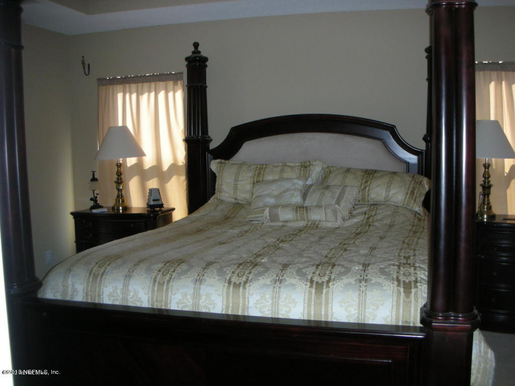 3409 South Saxxon Road St. Augustine, FL 32092 - Photo 9 of 15 a bedroom with a balcony bed and a window