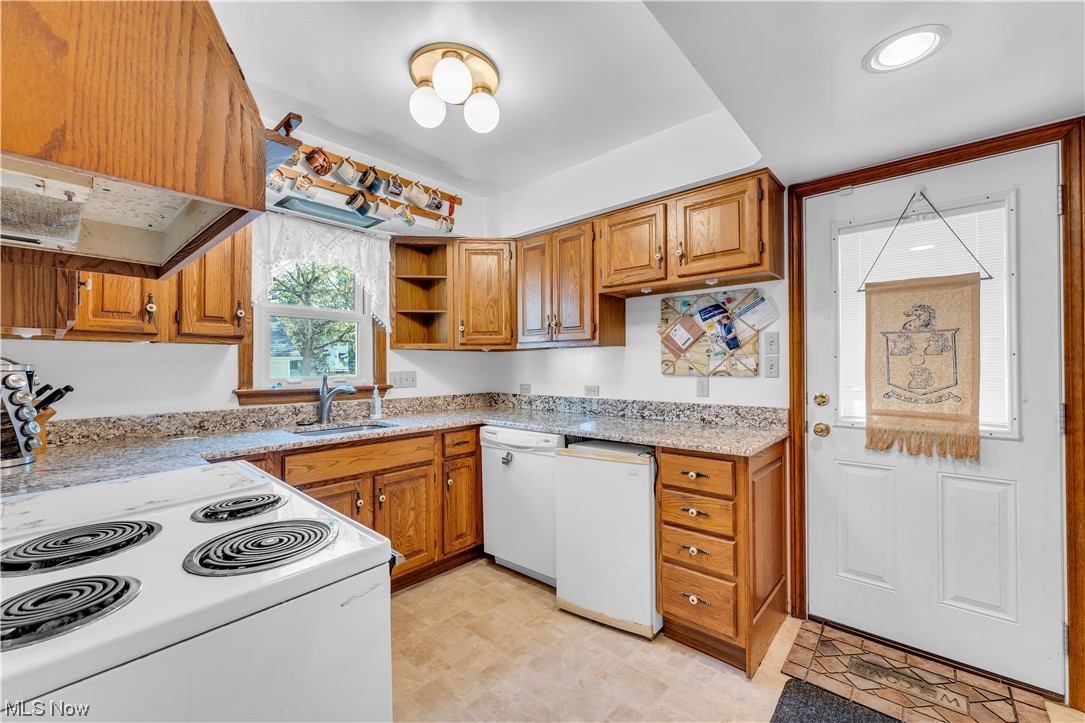 1195 Roland Road Cleveland, OH 44124 - Photo 6 of 34 Kitchen with stove, dishwasher, custom exhaust hood, and light tile floors