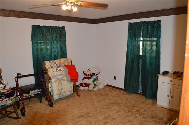 517 Second Plumb Road Belvidere, TN 37306 - Photo 12 of 20 a bedroom with a bed and a chandelier