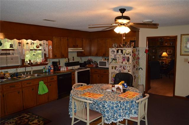 517 Second Plumb Road Belvidere, TN 37306 - Photo 7 of 20 a kitchen with granite countertop a stove a sink dishwasher and a refrigerator with wooden floor
