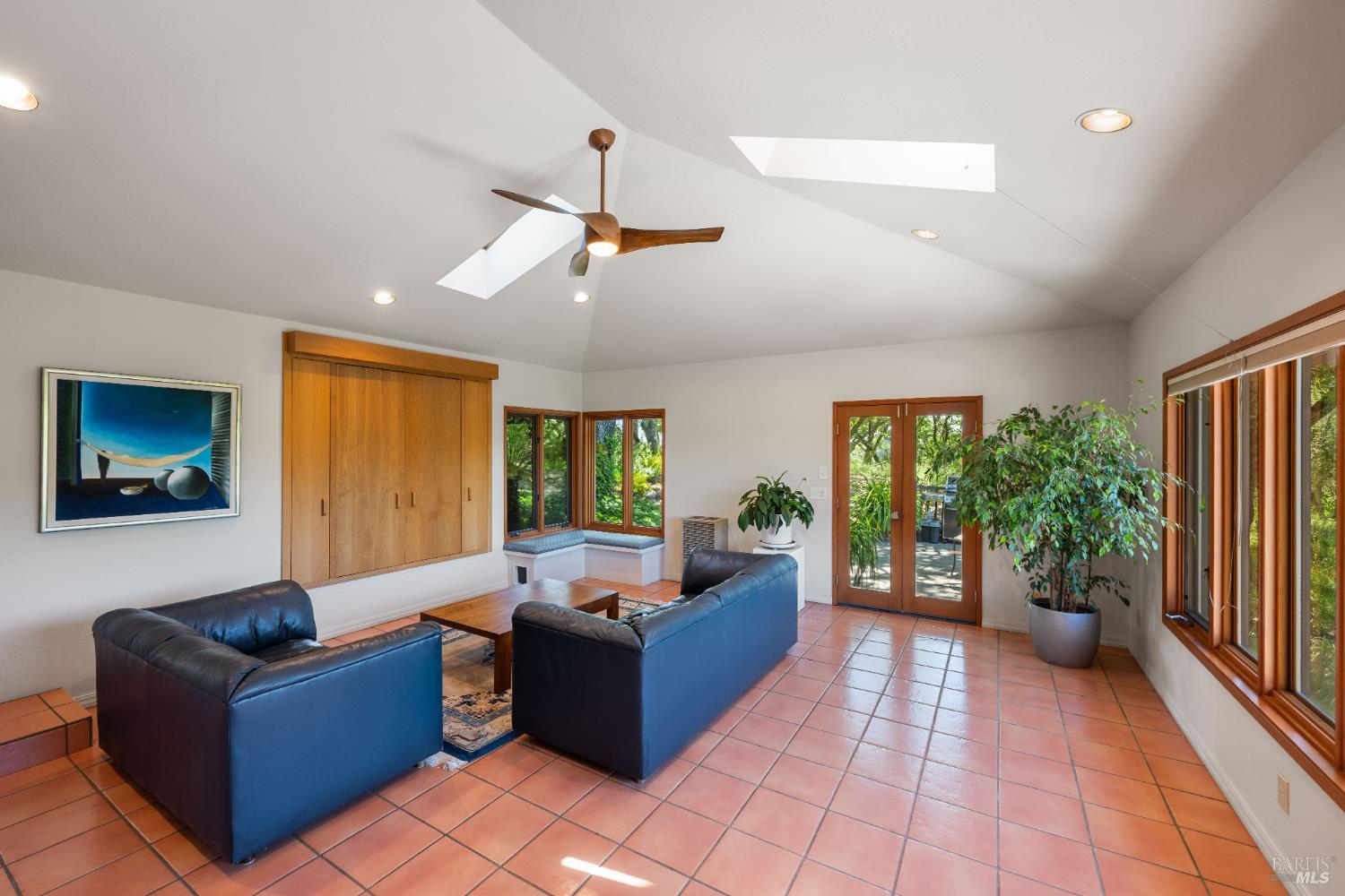 10601 Slattery Road Glen Ellen, CA 95442 - Photo 22 of 45 The family room with lounging and reading areas accesses the grounds with multiple garden-lined paths. Tile floor, picture windows to the views, built-in entertainment center.