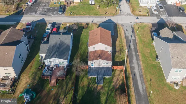 an aerial view of residential houses with outdoor space