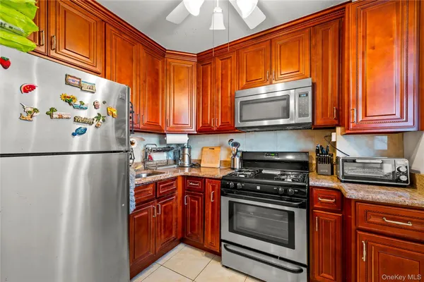 a kitchen with stainless steel appliances granite countertop a refrigerator a stove a sink and dishwasher