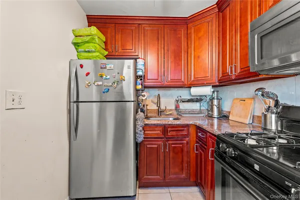a kitchen with stainless steel appliances granite countertop a refrigerator and a stove top oven
