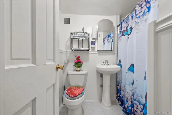 a bathroom with a sink and mirror with toilet