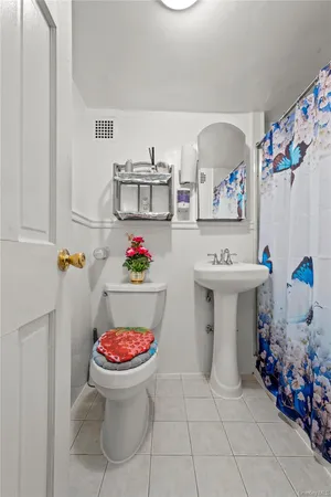 a bathroom with a sink toilet and mirror