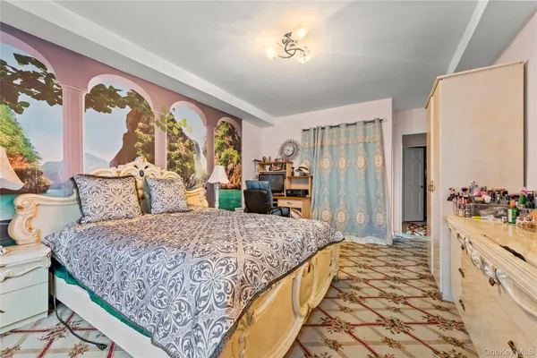 a spacious bedroom with a bed and a chandelier