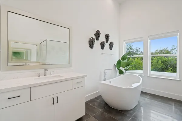 a bathroom with a bathtub and a sink