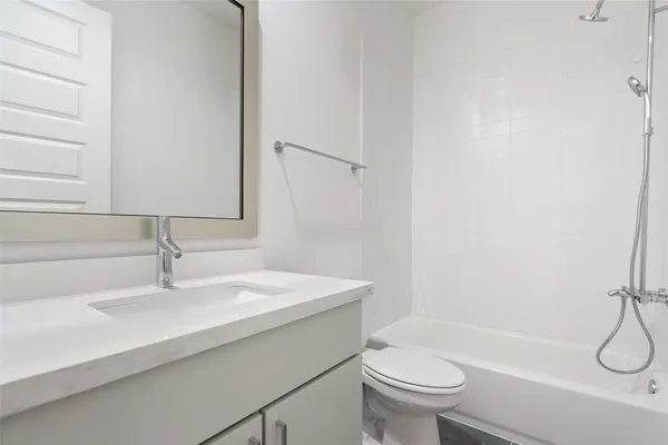 a bathroom with a sink a toilet and a tub
