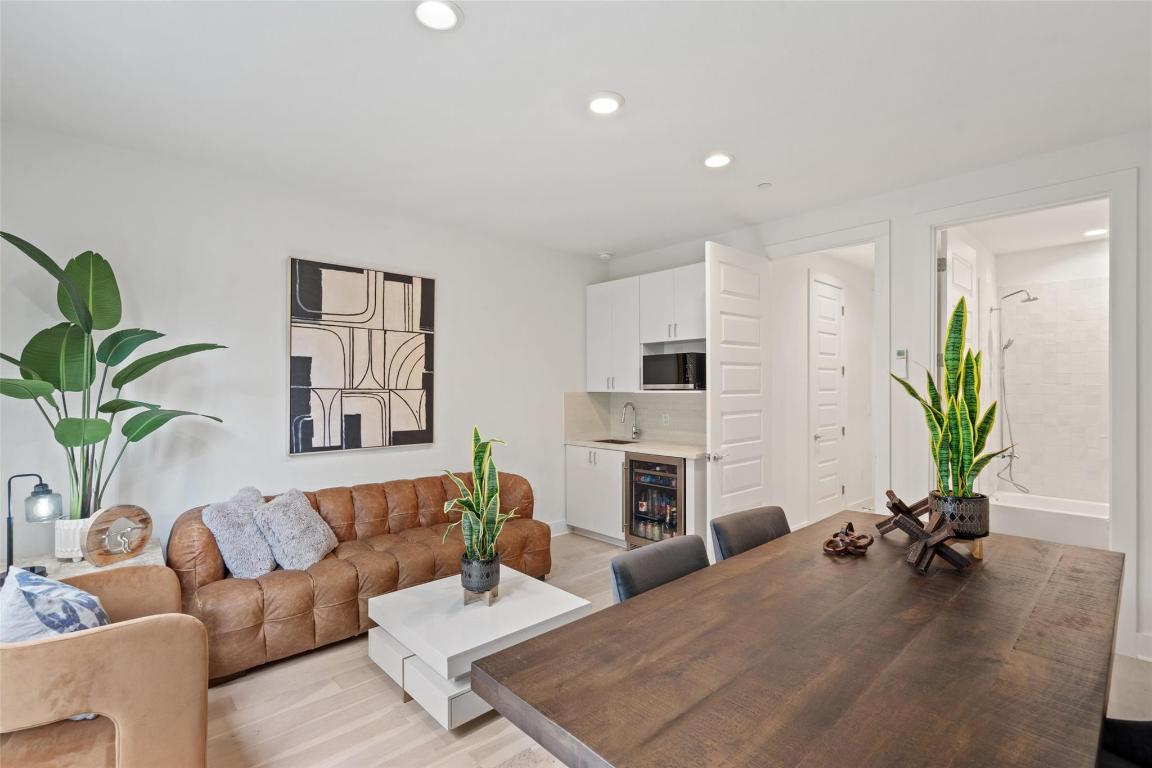 2505 Bluebonnet Lane, Unit 13 Austin, TX 78704 - Photo 19 of 29 Living area with a bar, recessed lighting, light wood-type flooring, and wine cooler