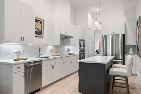 a kitchen with stainless steel appliances a sink stove and refrigerator