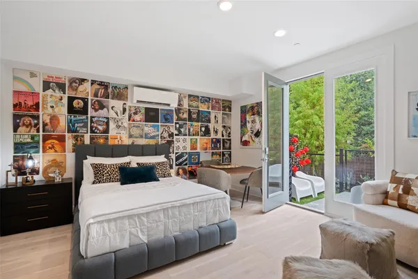 a bedroom with a large bed and a bookshelf