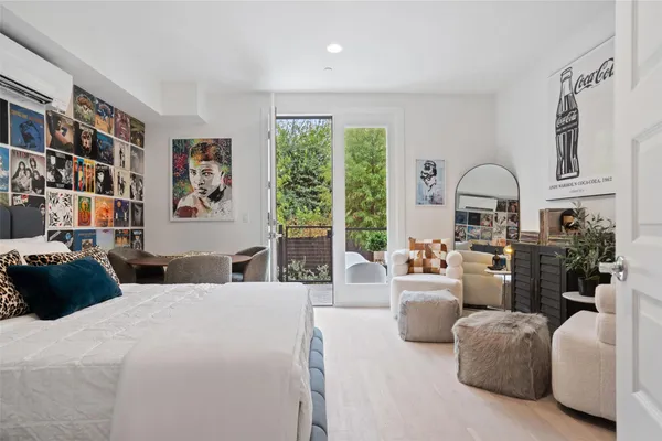 a bedroom with furniture and a large window