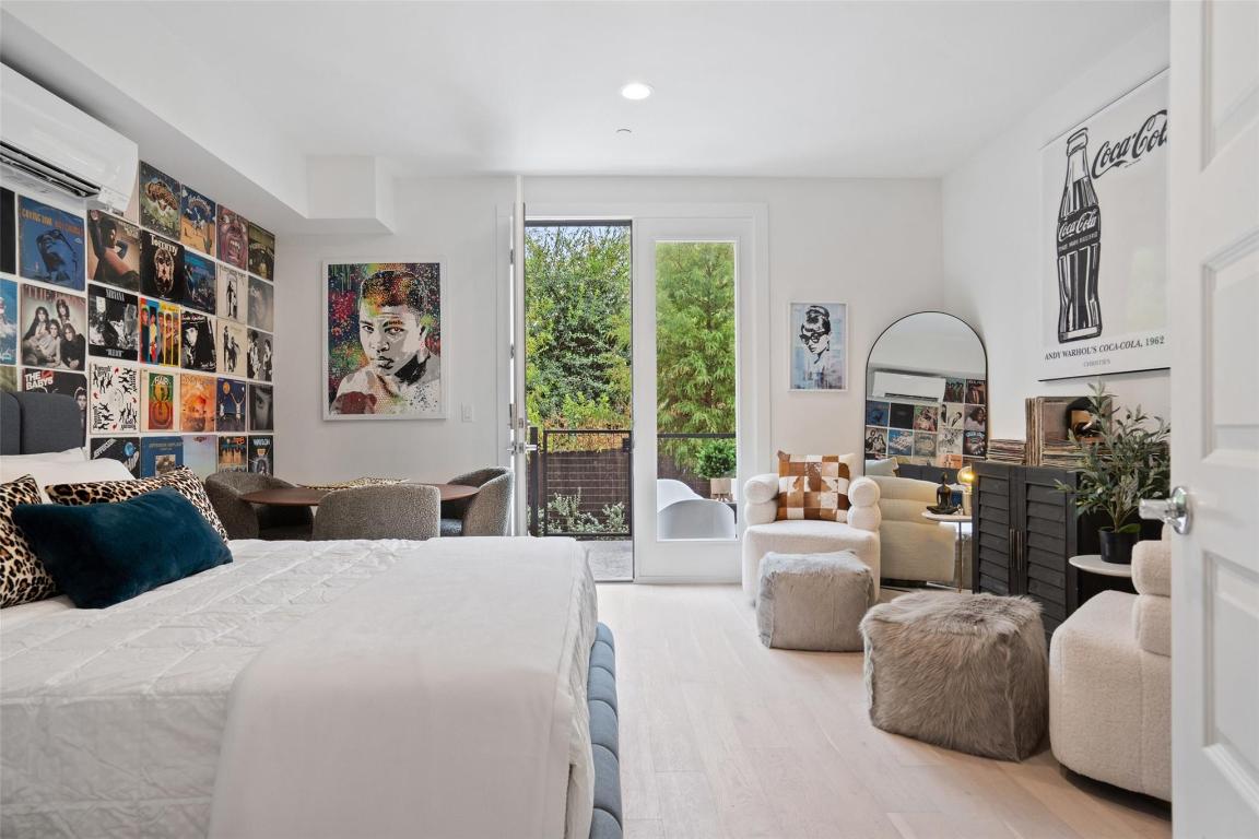 2505 Bluebonnet Lane, Unit 13 Austin, TX 78704 - Photo 23 of 29 Bedroom with access to exterior, wood finished floors, a wall mounted AC, and recessed lighting