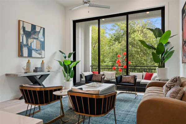 a living room with furniture a table and a potted plant