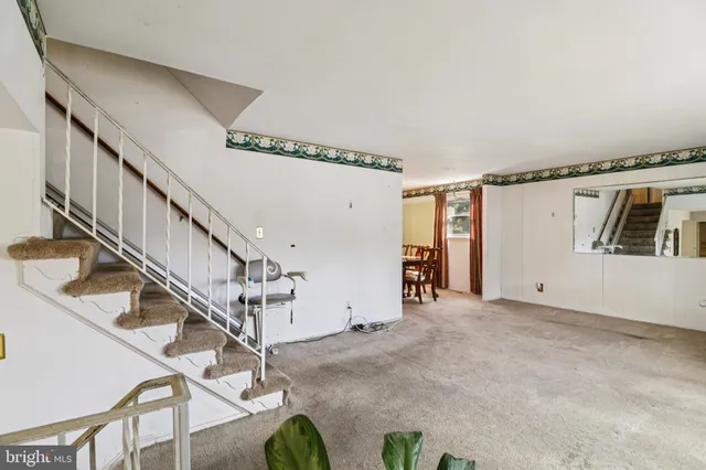 a view of a dining room with furniture a chandelier and wooden floor