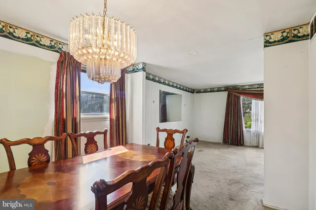 a kitchen with stainless steel appliances kitchen island granite countertop a stove top oven a sink and white cabinets