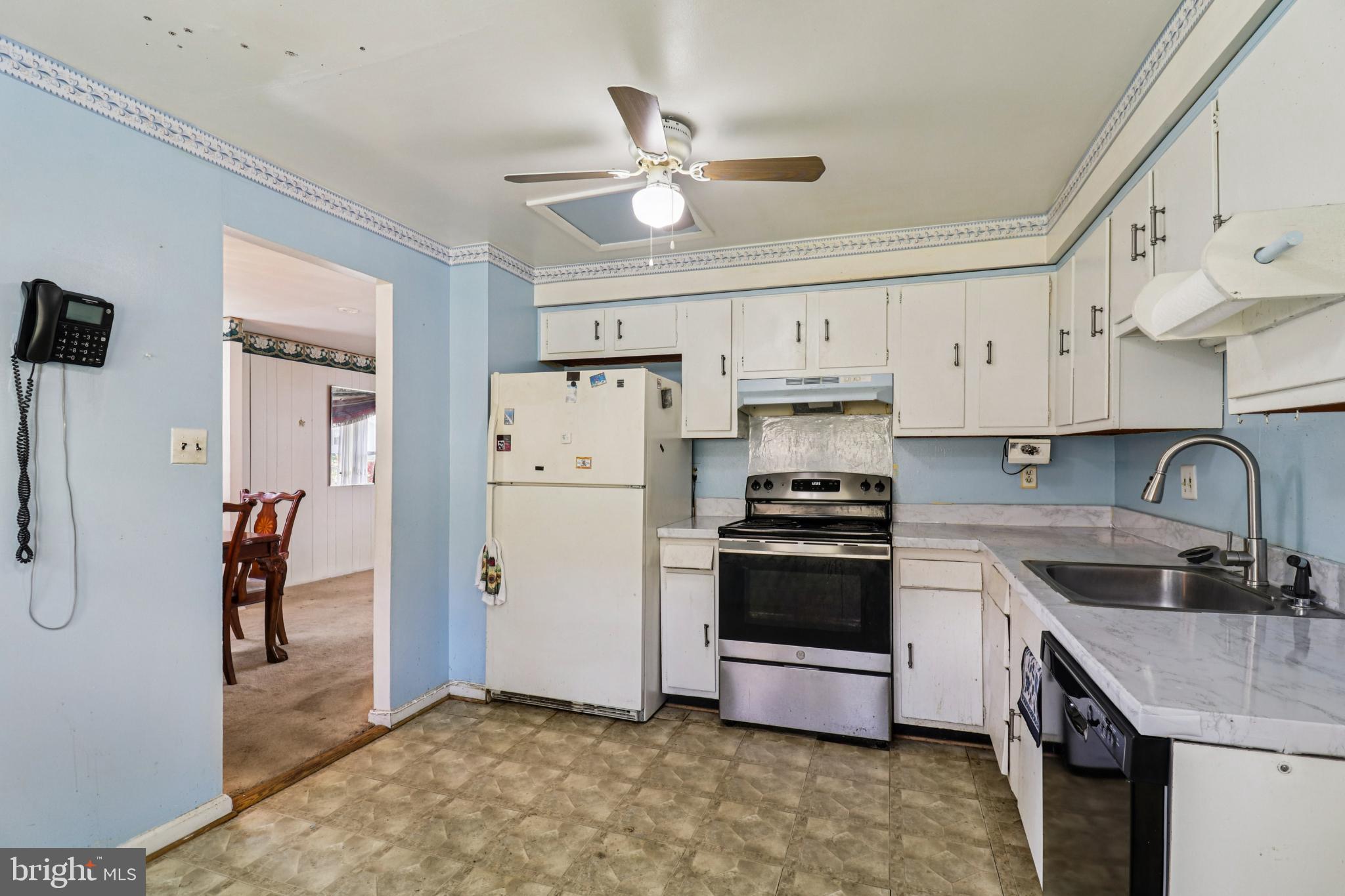 1916 Taylor Avenue Fort Washington, MD 20744 - Photo 16 of 64 a kitchen with white cabinets and stainless steel appliances