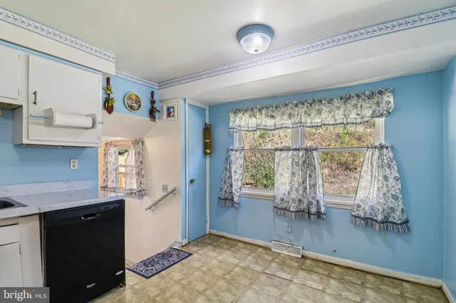 a view of a room with rack on the wall and a window