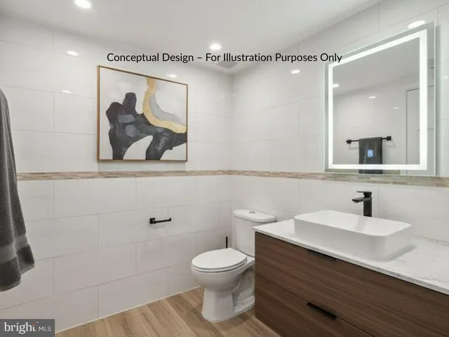 a bathroom with a sink toilet vanity and shower