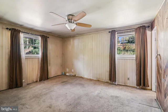 a view of a livingroom with a ceiling fan and window