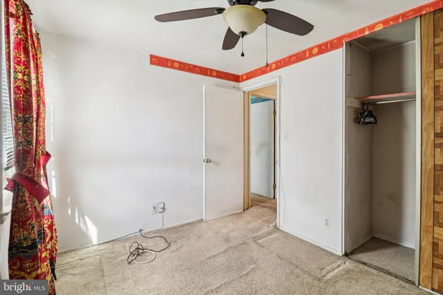 a view of a house with wooden fence