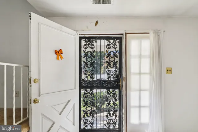 a view of a hallway to a livingroom with furniture