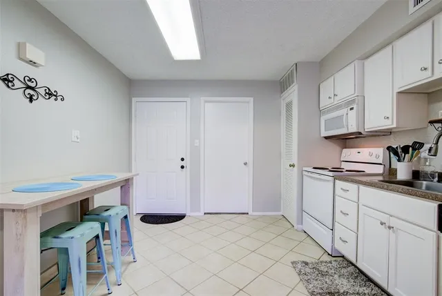 a kitchen with stainless steel appliances kitchen island granite countertop a refrigerator and a stove top oven