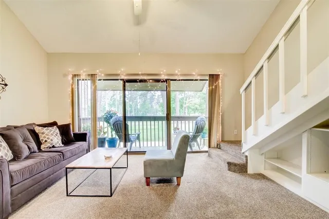 a living room with furniture and a large window with outer view