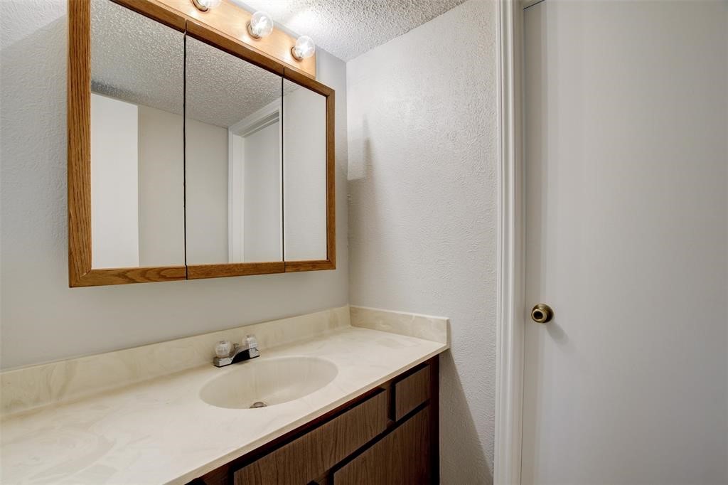 12900 Walden Road, Unit 202B Montgomery, TX 77356 - Photo 18 of 30 a bathroom with a sink and a mirror