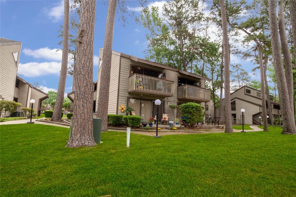 12900 Walden Road, Unit 202B Montgomery, TX 77356 - Photo 2 of 30 a view of a building with a yard