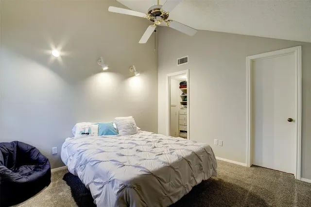 a bedroom with a bed and ceiling fan