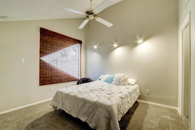 a bedroom with a bed and a painting on the wall